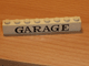 Part No: crssprt01pb26 Name: Brick 1 x 8 without Bottom Tubes with Cross Side Supports with Black 'GARAGE' Serif Pattern Part No: crssprt01pb26 Name: Brick 1 x 8 without Bottom Tubes with Cross Side Supports with Black 'GARAGE' Serif Pattern