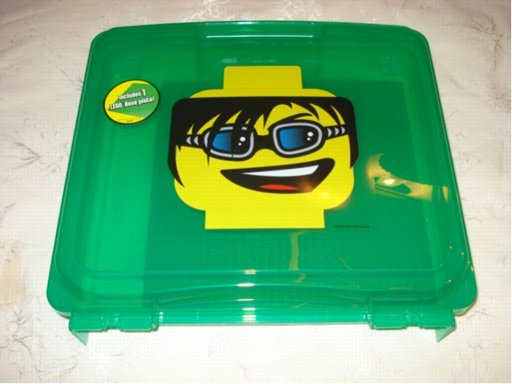 Project Case with Baseplate, Trans-Green with Minifigure Head with Black Hair, Goggles, and Open Mouth Smile with Top Teeth and Red Tongue Pattern