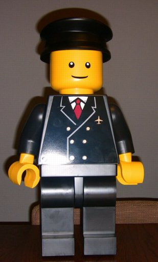 Display Figure 7in x 11in x 19in (black jacket, black pants, black hat, Airport)