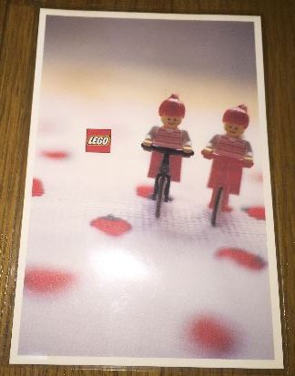 Postcard - Lego Art Project 2000 - 008 - 2 Female Minifigures Riding Bicycles
