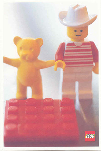 Postcard - Lego Art Project 2002 - 027 - Minifigure with Yellow Bear Behind Red Brick