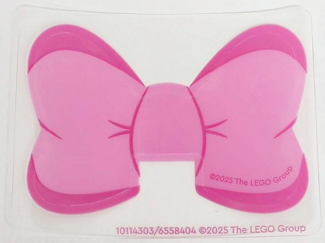 Plastic Bow with Magenta Edges and Creases on Dark Pink Background Pattern