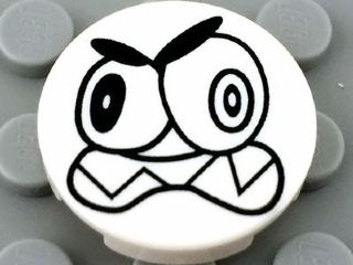 Tile, Round 2 x 2 with Bottom Stud Holder with Black Large Eyes and Scowl with Sharp Teeth (Nixel Face) Pattern