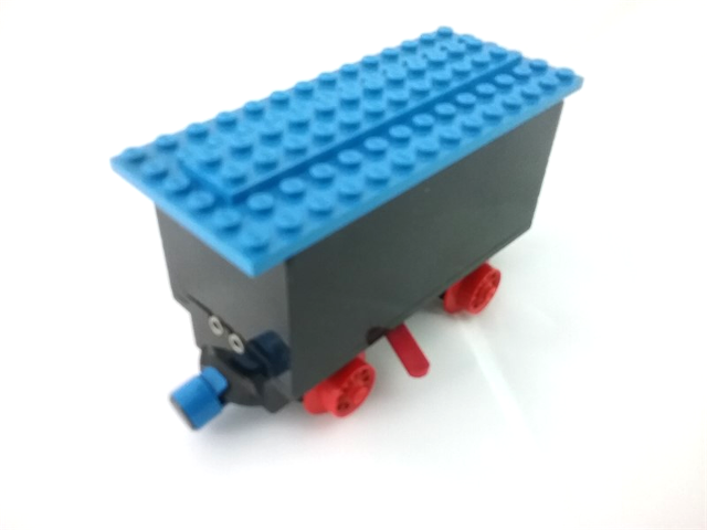 Train Battery Box Car with Two Contact Holes, Red Switch Lever, Blue and Red Magnets, Red Wheels, and Blue Roof