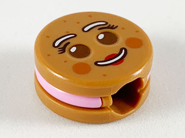 Minifigure, Head, Modified Cookie Shape with Reddish Brown Eyes, Bright Pink Frosting, White Eyebrows and Mouth, Red Lips Pattern (Gingerbread Woman)