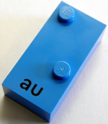 Brick, Braille 2 x 4 with 2 Studs with Black Lowercase Letters au Pattern (dots-16 ⠡) (German)