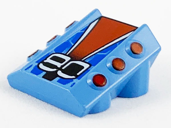 Brick, Modified 2 x 2 No Studs, Sloped with 6 Side Pistons Raised with Stylized '80' on Red, White, Black, and Blue Pattern