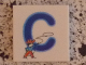 Part No: 3068pb0712  Name: Tile 2 x 2 with Letter C Blue with Cowboy Pattern