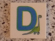 Part No: 3068pb0713  Name: Tile 2 x 2 with Letter D Blue with Dinosaur Pattern