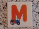 Part No: 3068pb0722  Name: Tile 2 x 2 with Letter M Red with Motorcycle Pattern