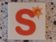Part No: 3068pb0728  Name: Tile 2 x 2 with Letter S Red with Sun Pattern