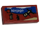 Part No: 3069pb1047  Name: Tile 1 x 2 with LEGO Ninjago Set Box Art, Black Ninja Minifigure Silhouette and Boulder Blaster Pattern (Sticker) - Sets 40528 / 40574