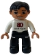 Minifig No: 47394pb181  Name: Duplo Figure Lego Ville, Male, Black Legs, White Top, Black Hair, '80 evesek vagyunk' on Front, LEGO Logo on Back
