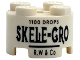 Part No: 3941pb61  Name: Brick, Round 2 x 2 with Axle Hole with Black '1100 DROPS', 'SKELE-GRO' and 'R.W & Co' Pattern