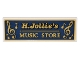 Part No: 69729pb053  Name: Tile 2 x 6 with Gold 'H. Jollie's MUSIC STORE' and Music Notes Pattern (Sticker) - Set 10308