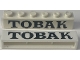 Part No: crssprt02pb041a  Name: Brick 1 x 6 without Bottom Tubes with Cross Side Supports with Black 'TOBAK' Serif Pattern