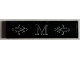 Part No: 2431pb0748 Name: Tile 1 x 4 with Silver Letter M and Ornate Scrollwork Pattern Background (Sticker) - Set 21330 Part No: 2431pb0748 Name: Tile 1 x 4 with Silver Letter M and Ornate Scrollwork Pattern Background (Sticker) - Set 21330