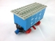 Part No: 3443c06pb01  Name: Train Battery Box Car with Two Contact Holes, Red Switch Lever, Blue and Red Magnets, Red Wheels, and Light Gray Roof with Hinged Doors Pattern on Both Sides (Stickers) - Set 7720