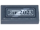 Part No: 3069pb1356  Name: Tile 1 x 2 with Black and Light Bluish Gray Plaque with White Diagonal Stripe and 'Est. 2023' Pattern (Sticker) - Set 42670