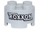 Lego part: Brick, Round 2 x 2 with Axle Hole with Black and White 'ROXXON' Logo Pattern (Sticker) - Set 76269