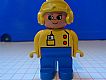 invID: 200448371 M-No: 4555pb107  Name: Duplo Figure, Female, Blue Legs, Yellow Top with Radio in Pocket, Yellow Aviator Helmet, Eyelashes, Turned Down Nose